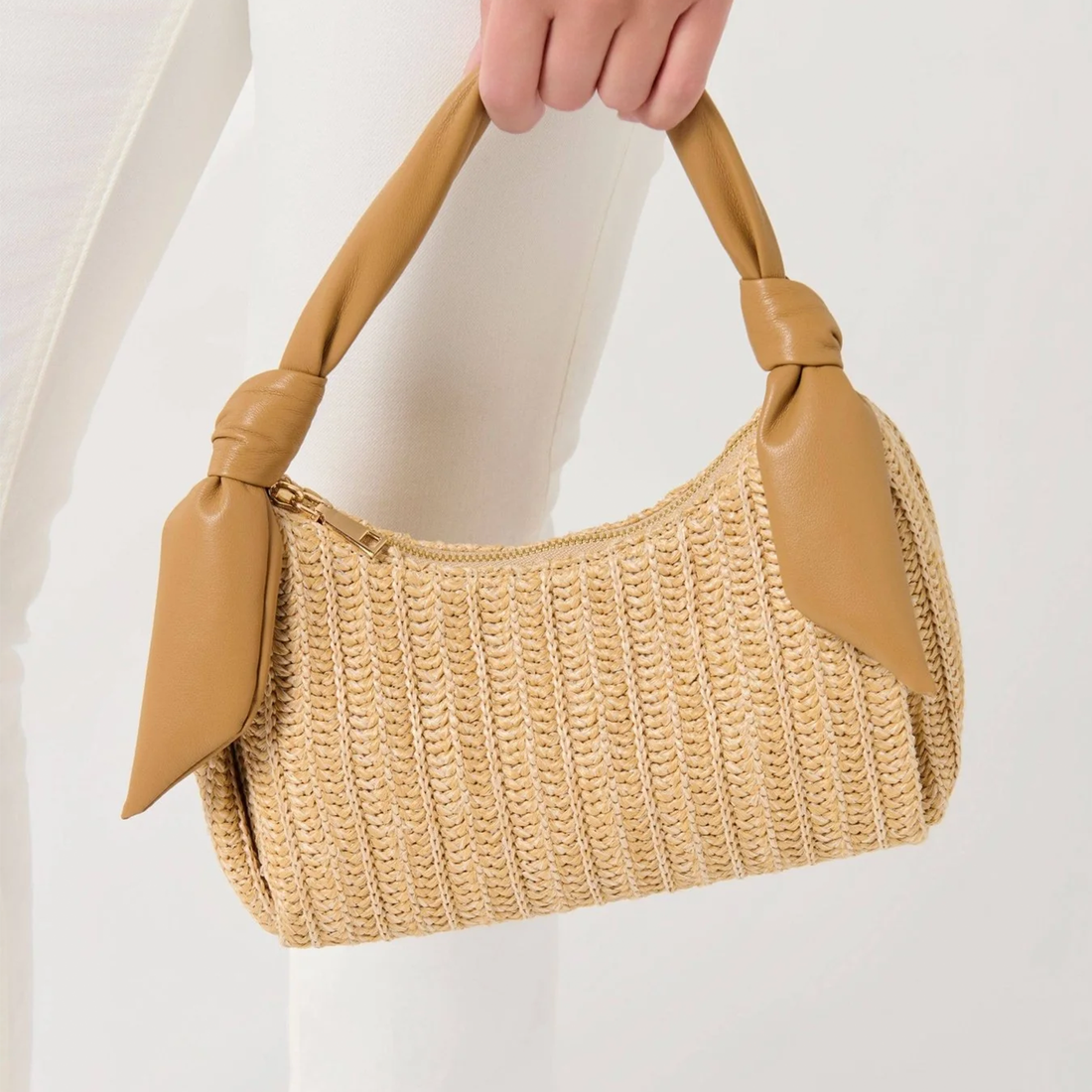 Natural Straw Beige Vertical Knit Curved Hobo Handbag With Tan Knotted Bow Top Handle And Metallic Slide Seal Closure