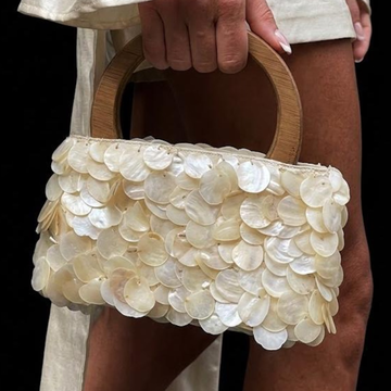 Pale Off-White Stacked Iridescent Shell Slice Curved Handheld Bag With Smooth Circular Loop Top Grip And Secure Enclosed Storage Opening